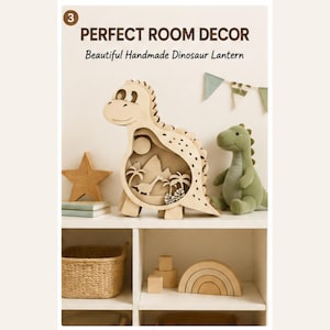 May include: A light-colored wooden dinosaur-shaped lantern featuring a cutout scene of a smaller dinosaur, palm trees, and a sun. The text "3 PERFECT ROOM DECOR Beautiful Handmade Dinosaur Lantern" is visible at the top of the image.