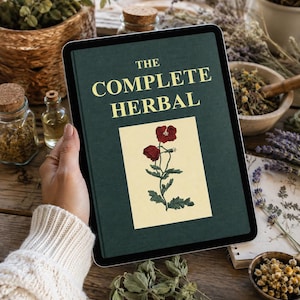 Puede incluir: Una tableta digital que muestra la portada de un libro titulada THE COMPLETE HERBAL en texto amarillo sobre un fondo verde oscuro, con una ilustración central de una amapola roja con hojas verdes sobre un recuadro de color crema.