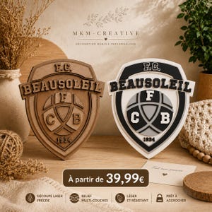 May include: Two wooden and white layered wall decorations featuring the text "F.C. BEAUSOLEIL" and a shield design with the letters "F", "C", and "B", and the number "1934". The decorations are in a shield shape.