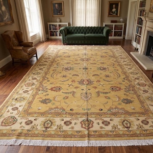 May include: A large rectangular area rug featuring a golden yellow field with a central floral medallion and intricate botanical motifs in shades of red, blue, and green. The rug has a wide cream border with floral patterns and white fringe.