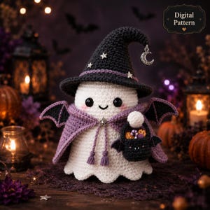 May include: A white crocheted ghost figurine wearing a dark gray pointed hat with silver star charms and a crescent moon charm. The ghost has black eyes, pink cheeks, a purple cape with bat wings, and carries a small black bat-shaped basket.