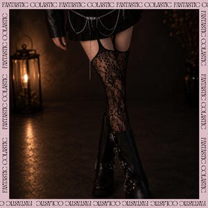 May include: Black lace thigh-high stockings featuring a floral pattern and integrated garter straps. The stockings are paired with black leather boots and a black pleated skirt with a silver chain belt. The border text reads FANTASTIC COLASTIC.
