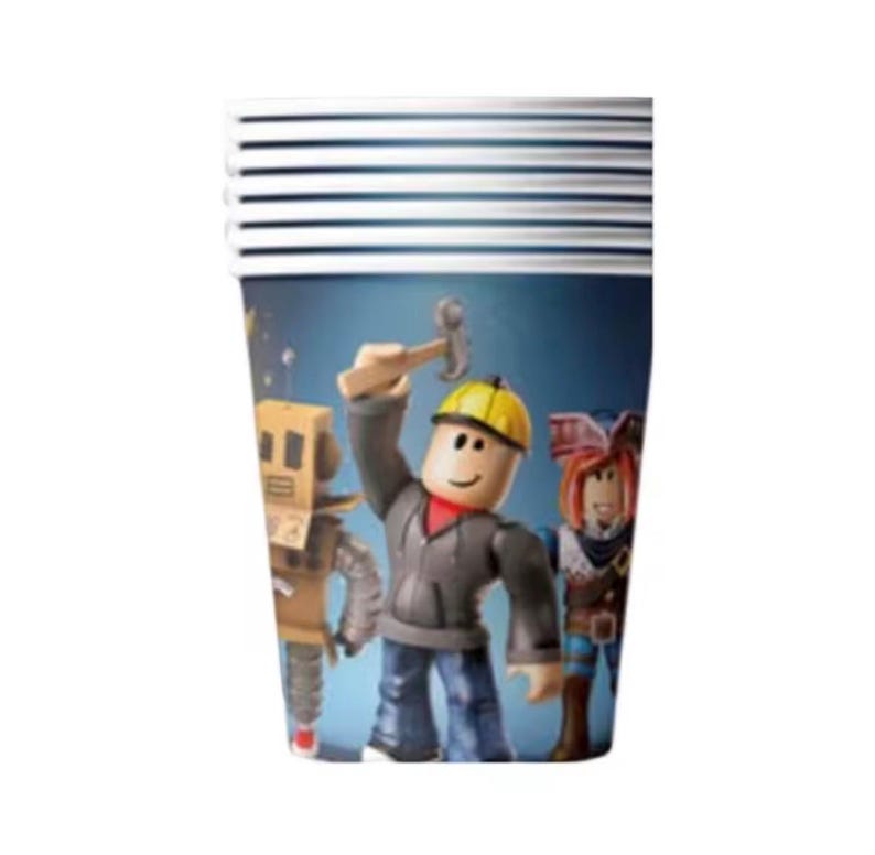 May include: A stack of disposable paper cups featuring a blue background with a printed graphic of three block-style characters. The central character wears a yellow hard hat and holds a hammer, flanked by a robot figure and a pirate-themed character.