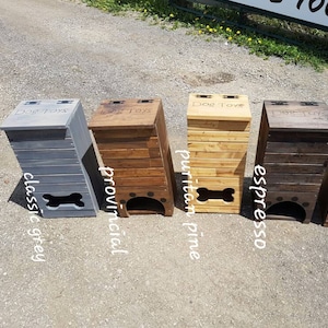May include: Four wooden dog toy storage bins with different stain colors. The bins are labeled "Dog Toys" and have a bone-shaped opening. The colors are classic grey, provincial, puritan pine, and espresso.
