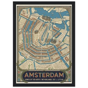 May include: A framed map print of Amsterdam featuring a detailed aerial view of the city canals and buildings in blue, beige, and brown tones. The text reads AMSTERDAM VENICE OF THE NORTH NETHERLANDS EST. c. 1275 AD with a laurel leaf border.
