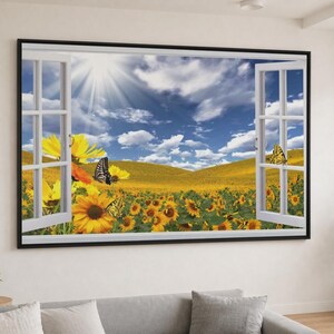 May include: A rectangular wall art print featuring a trompe l'oeil open window view of a vibrant yellow sunflower field under a bright blue sky with white clouds and sun rays. Two black and yellow butterflies rest on the flowers in the foreground.