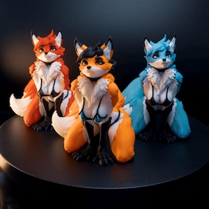 May include: Three anthropomorphic fox figurines in a kneeling pose. The left figure is orange and white, the centre figure is orange, black, and white, and the right figure is blue and white. Each figure wears a black bikini top and has white fur.