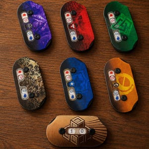 May include: Seven colourful game tokens with various designs and symbols. Each token has a unique colour, including purple, red, green, gold, blue, and orange. The tokens are arranged on a wooden surface.