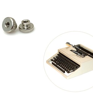 May include: Two silver-toned metal knurled nuts, and a vintage white typewriter with black keys.