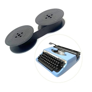 May include: A light blue portable typewriter with black keys and a metallic trim, accompanied by two black plastic spools connected by a black ink ribbon. The typewriter features the brand name Brother and the model name Charger 11 on the front.