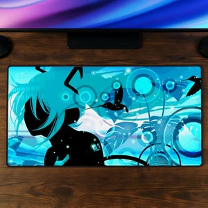 May include: A rectangular desk mat featuring a black silhouette of a character with long hair and the number 01 on the shoulder, set against a vibrant blue background with abstract circles, tropical leaves, and black hummingbird silhouettes.