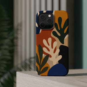May include: A smartphone case featuring an abstract organic pattern with overlapping shapes in shades of mustard yellow, terracotta orange, deep forest green, cream, and navy blue, with a triple-lens camera cutout at the top left corner.