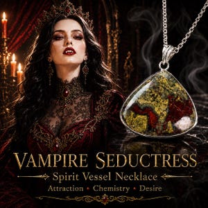 May include: A silver pendant necklace featuring a triangular stone with mottled green, gold, and deep red patterns. The text on the image reads: VAMPIRE SEDUCTRESS SPIRIT VESSEL NECKLACE Attraction Chemistry Desire. The pendant hangs from a silver chain.