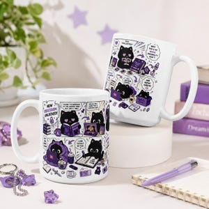 May include: Two white ceramic mugs featuring a black cat character in various scenes with purple accents. The mugs display comic-style illustrations with text including "NEW OBSESSION UNLOCKED!", "BIAS COLLECTED!", and "WAIT THIS IS MY WHOLE PERSONALITY NOW".