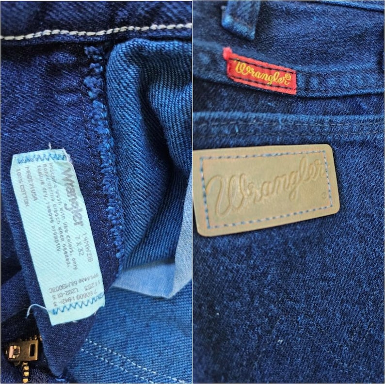 May include: Close-up of blue denim Wrangler jeans. The jeans have a red Wrangler tag on the back pocket and a leather patch with the Wrangler logo. The jeans also have a white tag with care instructions and the words "100% Cotton."