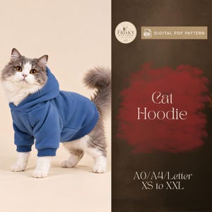 May include: A fluffy cat wearing a solid blue hoodie with ribbed cuffs and hem. The right side features text reading Frisky Pattern, Digital PDF Pattern, Cat Hoodie, and A0/A4/Letter XS to XXL on a dark brown background.