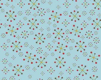 May include: A light blue fabric with a repeating pattern of starburst-like shapes. The starbursts have brown, red, and yellow-green elements. The fabric is marked with the text "Riley Blake Designs".