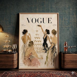 Op de afbeelding: Een ingelijste print van een vintage Vogue magazine cover. De illustratie toont vrouwen in avondjurken rond een champagnefontein. Het Vogue-logo staat bovenaan, met de tekst Paris, Avril 1931.