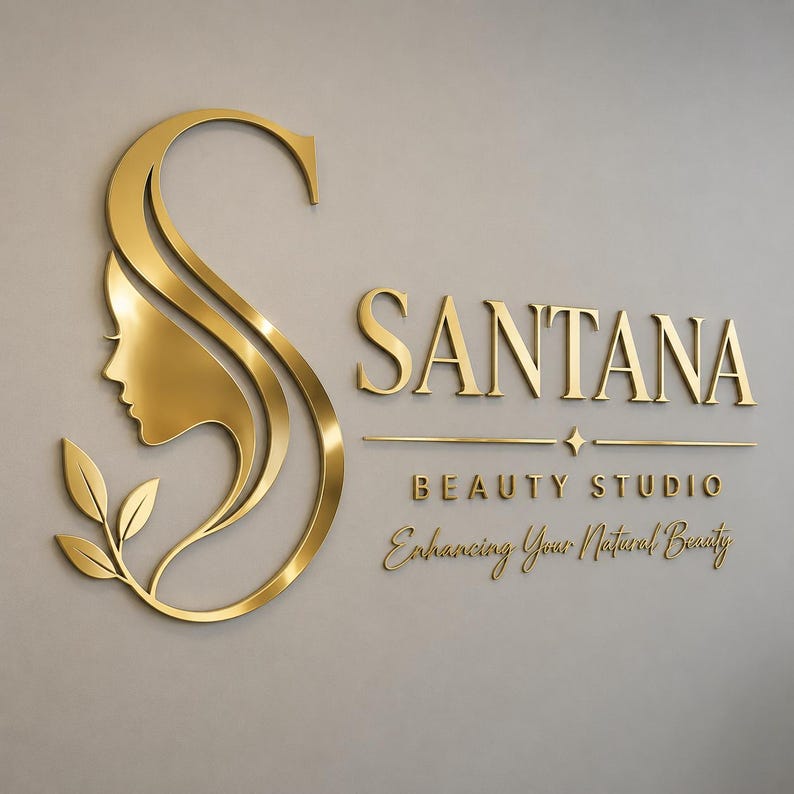 May include: A gold-colored wall sign featuring a large stylized letter S integrated with a profile silhouette of a face and three leaves. The text reads SANTANA BEAUTY STUDIO and Enhancing Your Natural Beauty in a serif and script font style.
