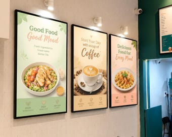 May include: Three rectangular wall-mounted signs with black frames. The left sign shows a salad with text reading Good Food Good Mood. The center sign features a cup of coffee with text reading Start Your Day with a cup of Coffee. The right sign displays pasta with text reading Delicious Food for Every Mood.
