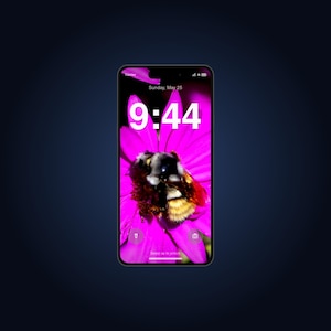 May include: A smartphone displaying a lock screen with a vibrant pink flower and a bumblebee. The screen shows the time 9:44, the date Sunday, May 25, a carrier signal, battery icon, and small icons for a flashlight and camera at the bottom.