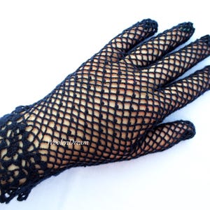 May include: Black crocheted gloves with a delicate lace pattern at the wrist. The gloves are made of a fine mesh material.