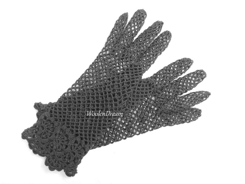 May include: A pair of black crocheted gloves with a delicate lace pattern at the wrist.