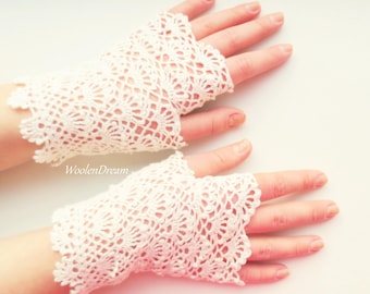 May include: A pair of white crocheted fingerless gloves with a delicate lace pattern. The gloves are made with a fine yarn and have a soft, airy feel.
