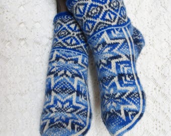 May include: A pair of blue and white knitted socks with a geometric pattern. The socks are made with a thick yarn and have a comfortable fit.