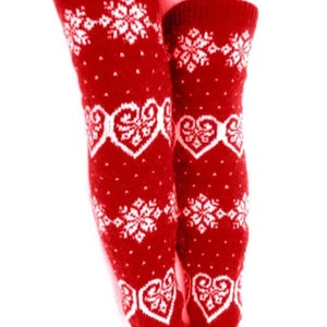 May include: Red knit leg warmers with white snowflake and heart patterns. These knee-high leg warmers are designed with a festive winter theme, perfect for adding a touch of warmth and style to any outfit.