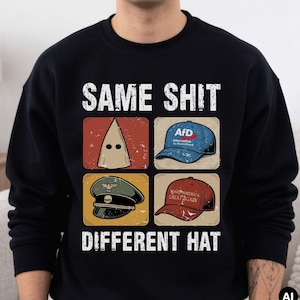 Könnte beinhalten: Ein schwarzes Langarm-Sweatshirt mit dem weißen Text "SAME SHIT" oben und "DIFFERENT HAT" unten. Die Grafik zeigt vier Quadrate mit einer beigen Kapuze, einer blauen AfD-Kappe, einer grünen Militärkappe mit Totenkopf und einer roten MAGA-Kappe.