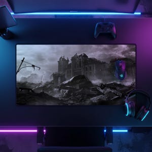 May include: A black gaming desk setup with a large mousemat featuring a grayscale apocalyptic scene. A gaming mouse, controller, and headset are visible. The desk is illuminated with blue and purple LED lights.
