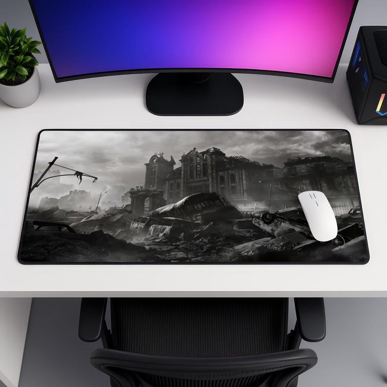 May include: A rectangular mouse mat with a black and white image of a ruined city. The design shows a destroyed building and rubble. A white computer mouse is positioned on the right side of the mat.