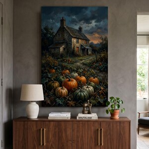 May include: A vertical wall art print depicting a stone cottage at dusk surrounded by a pumpkin patch. The scene features a dark, cloudy sky, orange pumpkins of various sizes nestled among green vines, and a rustic house with warm light in windows.