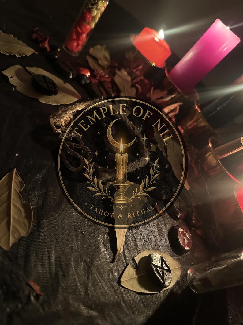 May include: A dark surface featuring scattered dried leaves, small black rune stones, and a glass vial filled with red items. Two lit candles, one orange and one pink, provide illumination. A circular logo reads Temple of Nil Tarot & Ritual.