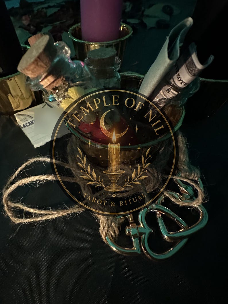May include: A collection of items including a glass bottle with a cork stopper, a purple candle in a gold-toned holder, and a rolled paper note. A metallic heart-shaped clasp is attached to a piece of twine. The text Temple of Nil Tarot & Ritual is visible.