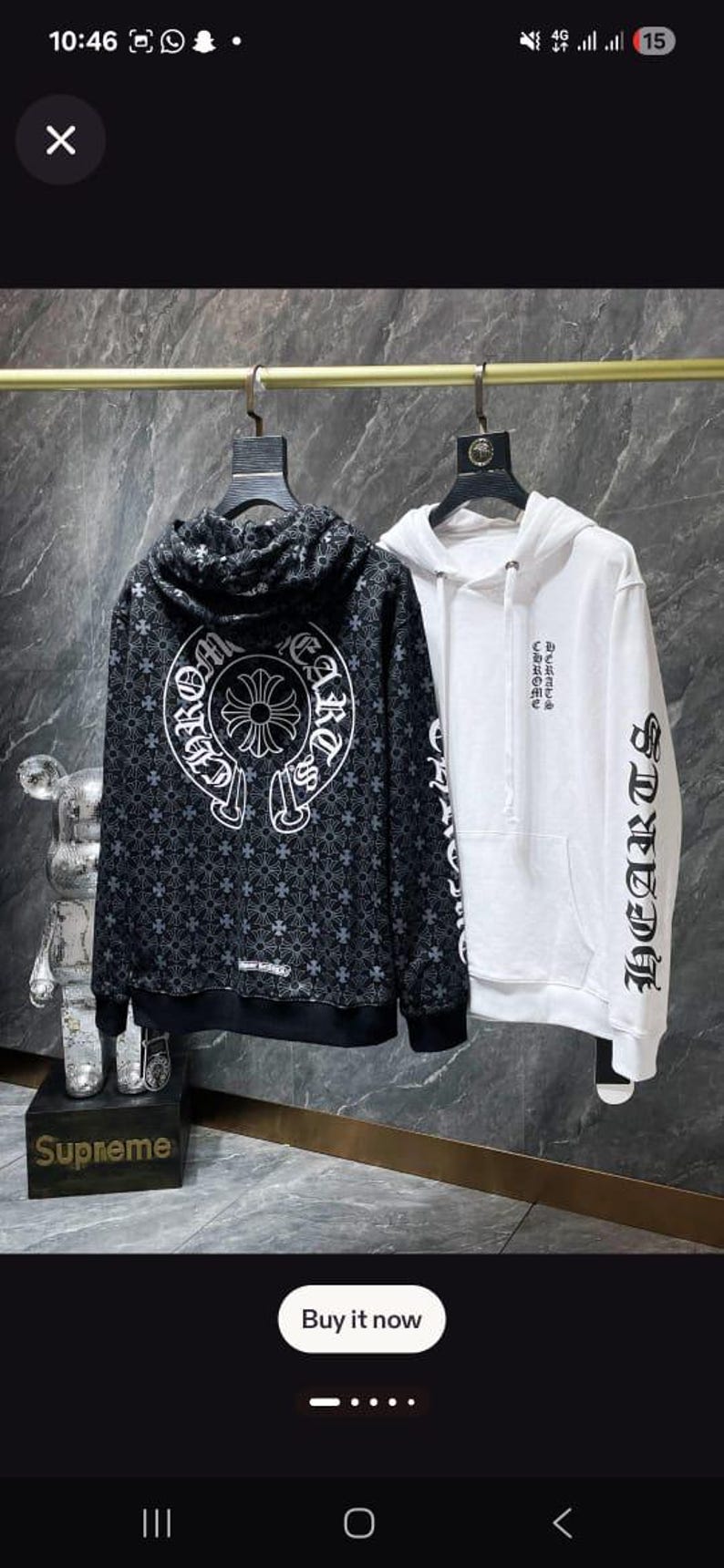 May include: Two hooded sweatshirts hanging on a rack. One is black with a white pattern and text, the other is white with black text on the sleeve. The word "HEARTS" is visible on the white sweatshirt.