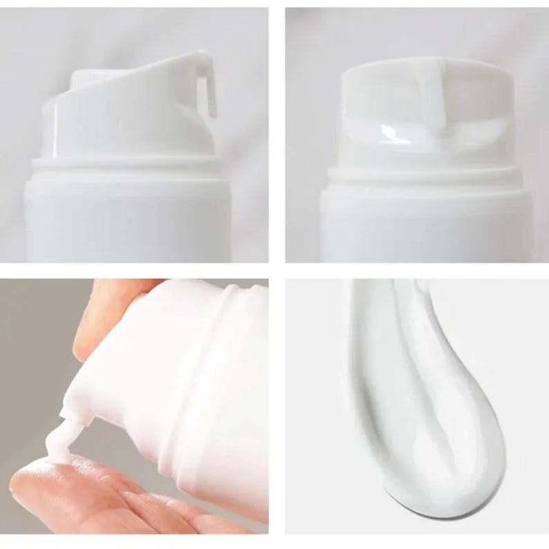 May include: A white cosmetic pump bottle with a smooth, cylindrical design. The dispenser mechanism is visible in multiple angles, showing a white, opaque cream being dispensed from the nozzle onto a surface, displaying a thick, creamy texture.