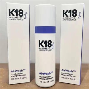 May include: A white cylindrical bottle of K18 Biomimetic Hairscience AirWash dry shampoo with a blue band, flanked by two matching white rectangular product boxes. Each item displays the text K18 Biomimetic Hairscience, AirWash, and 118 ml / 4 fl oz liq.