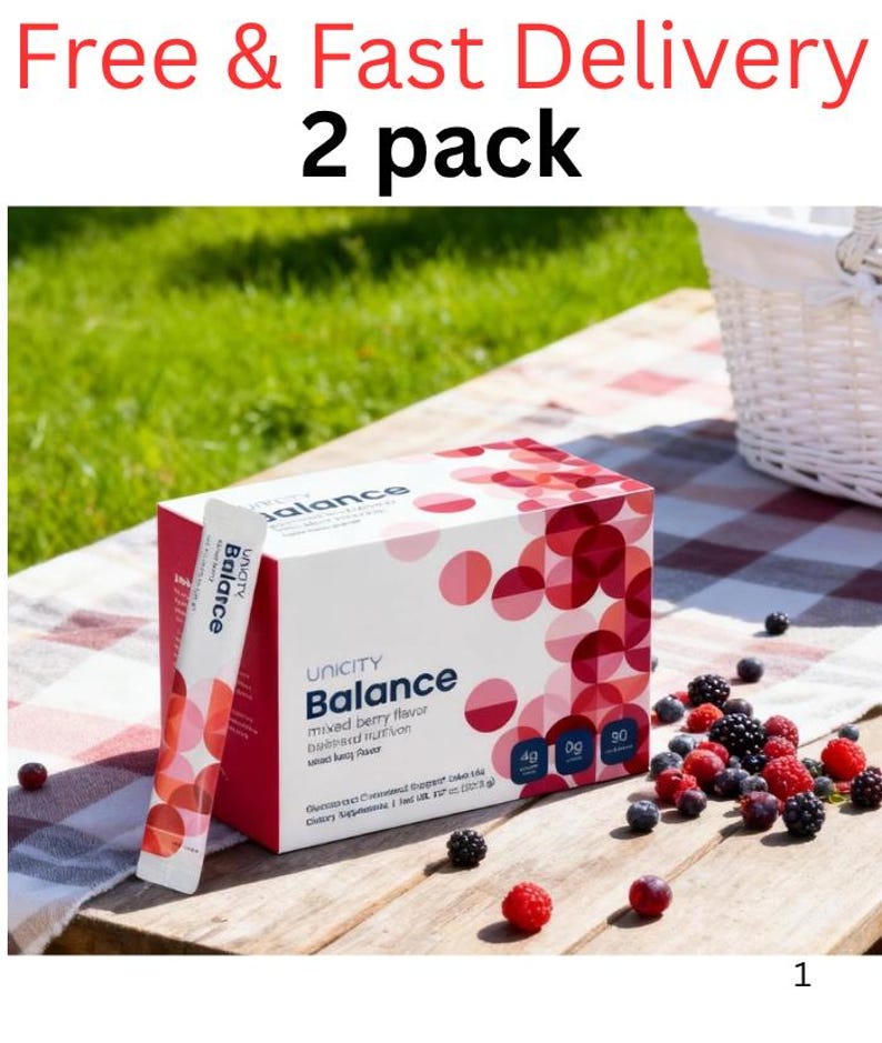 Pode incluir: Um pacote de 2 caixas de suplemento alimentar Unicity Balance sabor frutas vermelhas e sach&ecirc;s individuais. A embalagem branca apresenta um padr&atilde;o de c&iacute;rculos vermelhos e rosas, o texto "Unicity Balance" e os r&oacute;tulos "4g", "0g" e "90".