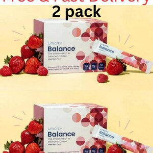 Pode incluir: Duas caixas e duas saquetas individuais de suplemento alimentar em p&oacute; Unicity Balance com sabor a frutos silvestres. A embalagem apresenta um padr&atilde;o geom&eacute;trico de c&iacute;rculos em tons de rosa e vermelho, com morangos e framboesas frescas.