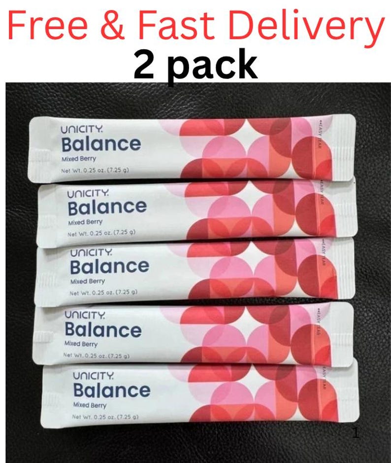 Pode incluir: Cinco saquetas de suplemento Unicity Balance Mixed Berry, cada uma com um peso l&iacute;quido de 7,25 g. A embalagem apresenta um padr&atilde;o geom&eacute;trico de c&iacute;rculos vermelhos e cor-de-rosa sobrepostos, com o nome da marca e sabor em texto azul.