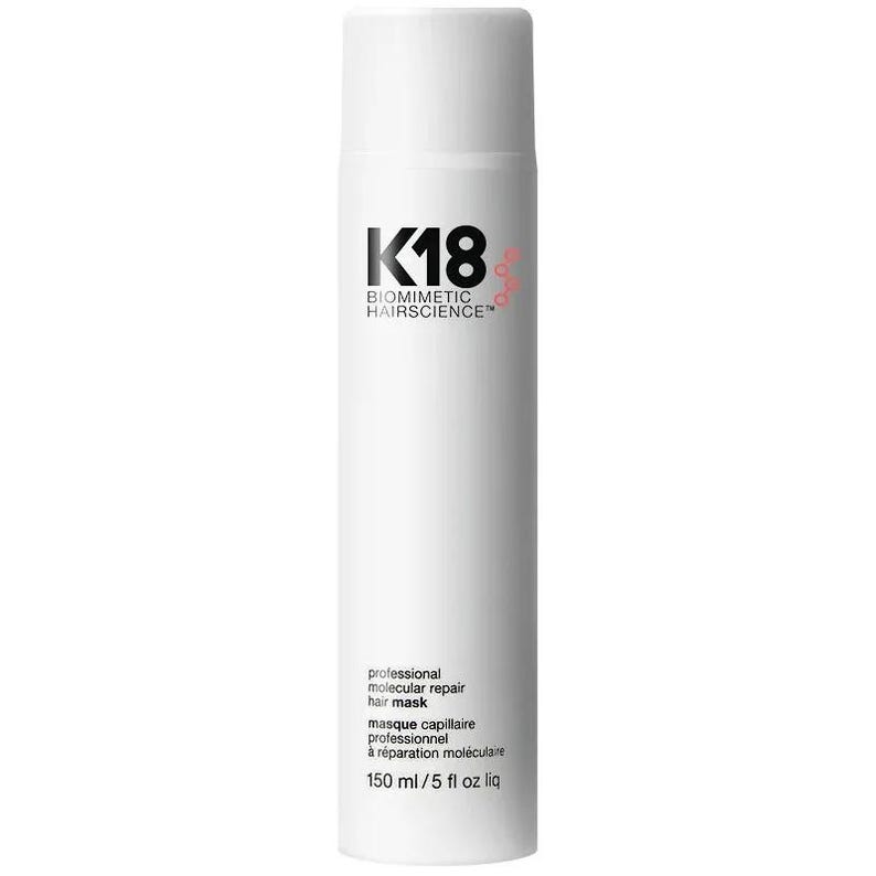 May include: A white cylindrical bottle of K18 Biomimetic Hairscience professional molecular repair hair mask. The label features black text and a small red circular graphic. The bottle contains 150 ml or 5 fl oz liq of product.