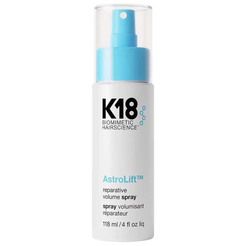 May include: A white cylindrical spray bottle with a light blue pump and clear cap. The label features black text reading K18 BIOMIMETIC HAIRSCIENCE, light blue text reading AstroLift, and black text reading reparative volume spray, 118 ml / 4 fl oz liq.