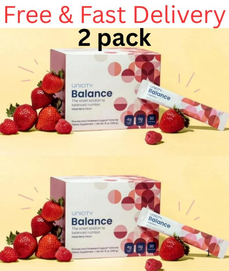 Pode incluir: Duas caixas e duas saquetas individuais de suplemento alimentar em p&oacute; Unicity Balance com sabor a frutos silvestres. A embalagem apresenta um padr&atilde;o geom&eacute;trico de c&iacute;rculos em tons de rosa e vermelho, com morangos e framboesas frescas.