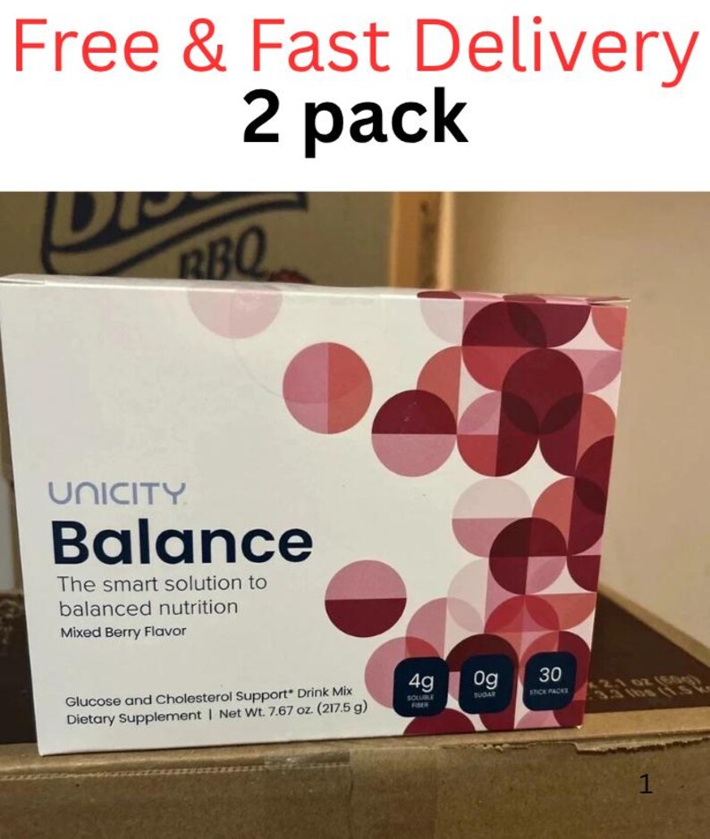 Pode incluir: Uma caixa retangular de suplemento diet&eacute;tico Unicity Balance, mistura para bebida com sabor de frutas vermelhas. A embalagem branca apresenta um padr&atilde;o geom&eacute;trico de c&iacute;rculos rosa e vermelho escuro. O texto inclui 4g de fibra, 0g de a&ccedil;&uacute;car.