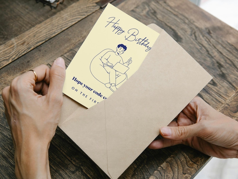 May include: A pale yellow birthday greeting card featuring a dark blue line drawing of a person sitting in a beanbag chair using a laptop with a thumbs up. The text reads Happy Birthday and Hope your code compiles ON THE FIRST TRY.