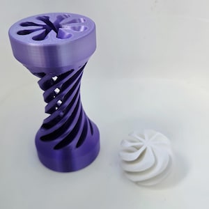 May include: A tall, purple, 3D-printed cylindrical object with a spiraling, open-lattice structure and a flower-shaped top, positioned next to a small, white, spherical object featuring a similar swirling, radial pattern on its surface.