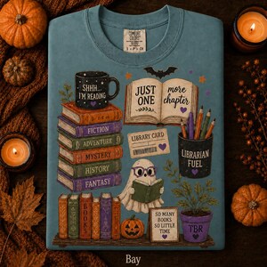 May include: A blue t-shirt featuring a graphic print of a stack of books labeled Fiction, Adventure, Mystery, History, and Fantasy, a ghost reading a book, a mug labeled Shhh I'm Reading, a pencil holder labeled Librarian Fuel, and text reading Just One More Chapter, Library Card, and So Many Books So Little Time.
