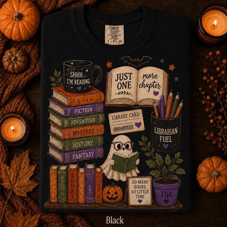 May include: A black t-shirt featuring a graphic print of stacked books labeled Fiction, Adventure, Mystery, History, and Fantasy. A ghost wearing purple glasses reads a book next to a mug labeled Shhh... I'm Reading and a pot labeled Librarian Fuel.